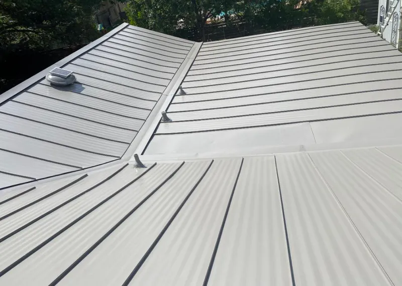 Solar attic fan installed on a metal roof for Roof Ventilation in White Lake